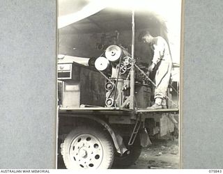 ALEXISHAFEN, NEW GUINEA. 1944-09-13. VX68609 SERGEANT W. MCDONALD OPERATING AN 8-FOOT BED LATHE IN THE MOBILE WORKSHOP OF THE 133RD BRIGADE WORKSHOPS