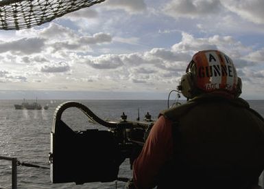 US Navy (USN) CHIEF Aviation Ordnanceman (AOC) Scott Kuczynski fires a twin M2.50 caliber machine gun, from onboard the USN Tarawa Class Amphibious Assault Ship, USS SAIPAN (LHA 2), at the decommissioned USN (former) Robert D. Conrad Class Oceanographic Research Ship, (now) Unclassified Miscellaneous (IX) Research Vessel, R/V GOSPORT (IX 517) in a live-fire Sink Exercise conducted 300 miles off the eastern seaboard of the United States. The R/V GOSPORT, other decommissioned vessels that were used as targets, were completely inspected by the US Environmental Protection Agency (EPA) before being sunk and will now serve as an artificial reef for deep-sea marine life