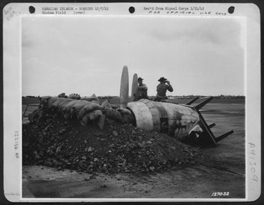 First Army Photos Of The Bombing Of Hawaii, Dec. 7, 1941. Soliders On Lookout For Enemy Planes In Make-Shift Machine Gun Nest Made From Bomb Crater And Motors From Destroyed Planes. Hickam Field, T.H. (U.S. Air Force Number 122156AC)