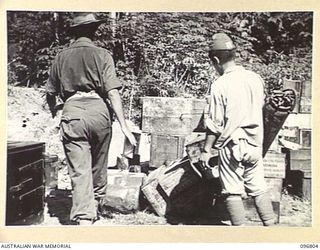 RABAUL, NEW BRITAIN. 1945-09-15. JAPANESE TROOPS WERE USED TO PREPARE CAMP SITES FOR HQ 11 DIVISION AND 4 INFANTRY BRIGADE. SHOWN, A JAPANESE SOLDIER USING DDT INSECTICIDE IN THE KITCHEN AREA OF HQ ..