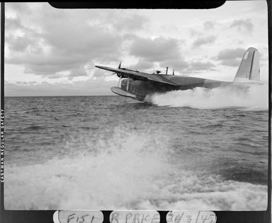 Short Sunderland flying boat, skimming across water, [in Fiji?]