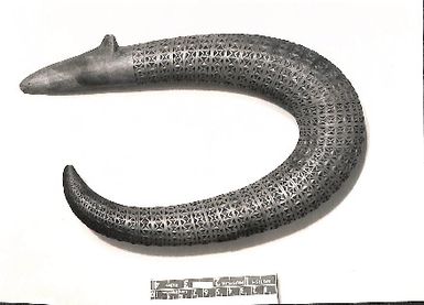Photo of a wooden hooked-shape art piece. British Museum (10413)