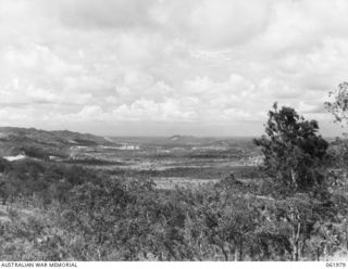 STOKES RANGE, PORT MORESBY AREA, NEW GUINEA. 1943-12-27. LOOKING UP FOUR MILE VALLEY TOWARDS WARD'S DROME FROM H8 HEAVY ANTI-AIRCRAFT GUN SITE, STOKES RANGE. CAMPS IN THE FOREGROUND ARE MURRAY ..