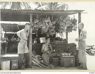 HANSA BAY AREA, NEW GUINEA. 1944-09-05. COOKS OF D COMPANY, 25TH INFANTRY BATTALION PROUDLY DISPLAY THEIR SUPPLY OF LOCAL FRESH FRUIT HANGING UP IN THE UNIT KITCHEN AT BOIKULU. IDENTIFIED PERSONNEL ..