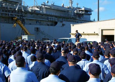 U.S. Navy (USN) CAPT. Leo Goff, manding Officer, L.Y. Spear Class Submarine Tender USS FRANK CABLE (AS 40), addresses the crew on Dec. 4, 2001, the Monday following a weekend boiler explosion aboard the ship. The Dec. 1 accident released superheated steam and critically injured six Sailors. They were stabilized and flown from Guam to Brooke Army Medical Center in San Antonio, TX, over the weekend. USN CAPT. Goff held an All Hands call to update the crew on their shipmates'conditions and discuss"the way ahead"for the ship. The FRANK CABLE is forward deployed to Guam, providing maintenance and logistical support to submarines deployed throughout the 7th Fleet. (U.S. Navy photo by Mass...