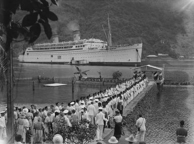 [official arrival or departure ceremony on Pacific Island jetty for passenger ship]