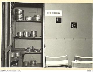 PORT MORESBY, NEW GUINEA, 1944-03-08. THE PROJECTION ROOM AND FILM LIBRARY AT "G" (VISUAL TRAINING), HEADQUARTERS, NEW GUINEA FORCE, VIEWED FROM THE THEATRETTE. THE PROJECTOR CAN BE SEEN THROUGH ..