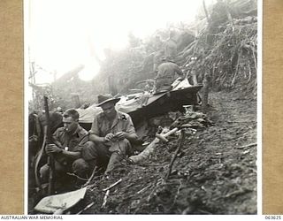 SHAGGY RIDGE, NEW GUINEA. 1944-01-20. QX34563 PRIVATE E. F. WESSLING OF MUNDUBBERA, QLD (1) AND QX37572 PRIVATE C. B. HENDERSON OF MONTO, QLD (2), BOTH MEMBERS OF THE SIGNALS SECTION, 2/9TH ..