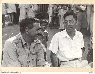 RATONGOR, NEW BRITAIN. 1945-10-10. MAJOR GENERAL B.M. MORRIS, COMMANDER, AUSTRALIAN NEW GUINEA ADMINISTRATIVE UNIT, AND MR B. AKUN, HEAD OF THE CHINESE COMMUNITY. THEY ARE ATTENDING THE GALA DAY ..