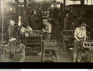 Port Moresby, New Guinea. 1944-05-30. Part of the Motor Transport Section of 126 Brigade Workshop, Australian Electrical and Mechanical Engineers (AEME). Note on the left a one ton improvised ..