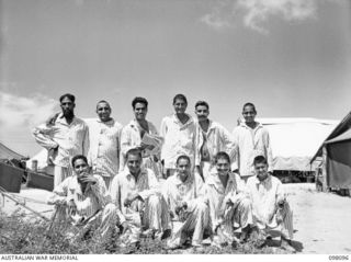 BORAM BEACH, NEW GUINEA. 1945-10-17. A GROUP OF INDIAN SOLDIERS, LIBERATED IN THE SEPIK RIVER AREA AND BROUGHT TO WEWAK FOR TREATMENT OUTSIDE A HOSPITAL WARD OF 2/15 FIELD AMBULANCE. WITH GOOD ..