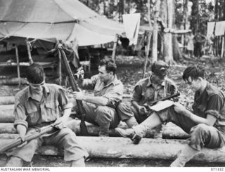WAREO, NEW GUINEA, 1944-03-20. MEMBERS OF THE 29/46TH INFANTRY BATTALION CLEANING EQUIPMENT AND WRITING LETTERS DURING A PAUSE IN STRENUOUS TRAINING. IDENTIFIED PERSONNEL ARE: VX14477 PRIVATE K.S. ..