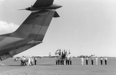 A joint service honor guard carries a casket containing the remains of an unidentified serviceman who was killed in Vietnam from a C-141B Starlifter aircraft during an arrival ceremony at the base