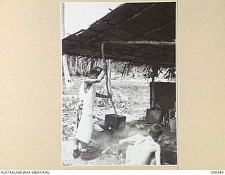 MUSCHU ISLAND, NEW GUINEA. 1945-10-27. TWO JAPANESE SOLDIERS BOILING AND SCRUBBING THEIR CLOTHES. JAPANESE TROOPS ARE CONCENTRATED ON MUSCHU ISLAND WHICH IS UNDER THE CONTROL OF HEADQUARTERS 6 ..