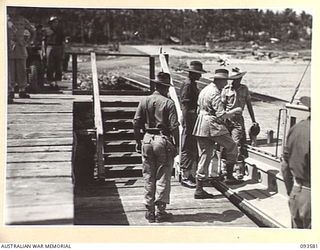 TOL PLANTATION, WIDE BAY, NEW BRITAIN. 1945-07-02. HIS ROYAL HIGHNESS, THE DUKE OF GLOUCESTER, GOVERNOR-GENERAL OF AUSTRALIA (2), GOING ABOARD A LAUNCH AT TOL WHARF AFTER HIS VISIT TO HEADQUARTERS ..