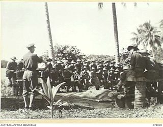 SIAR, NEW GUINEA. 1944-06-18. VX24325 BRIGADIER H.H. HAMMER, DSO, COMMANDING, 15TH INFANTRY BRIGADE, CONDUCTING A TEST FOR OFFICERS WHO HAVE COMPLETED A TACTICAL EXERCISE AT BRIGADE HEADQUARTERS