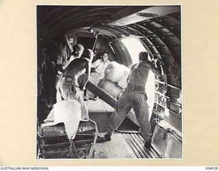NEW GUINEA. 1945-05-06. RATIONS AND STORES, FOR UNITS OF 17 INFANTRY BRIGADE, SUPPLIED BY HEADQUARTERS COMMAND, AUSTRALIAN ARMY SERVICE CORPS, 6 DIVISION, BEING DROPPED FROM A 36 SQUADRON, RAAF ..