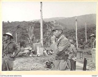 KAIRIRU ISLAND, NEW GUINEA. 1945-09-17. REAR-ADMIRAL S. SATO, FORMER JAPANESE NAVAL COMMANDER OF KAIRIRU AND MUSCHU ISLANDS WATCHING HIS TROOPS EMBARKING FOR TRANSFER BY BARGE TO MUSCHU ISLAND. ..