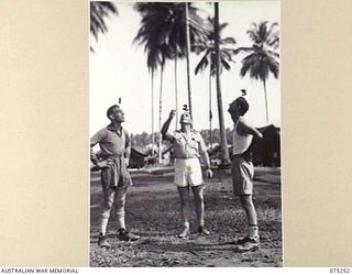 MILILAT, NEW GUINEA. 1944-08-13. THE CAPTAINS OF THE SOCCER TEAMS FROM THE 35TH INFANTRY BATTALION AND HEADQUARTERS, 5TH DIVISION TOSSING FOR ENDS BEFORE THE COMMENCEMENT OF THEIR MATCH. IDENTIFIED ..