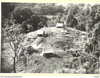 RAMU VALLEY, NEW GUINEA, 1944-02-29. "D" COMPANY, HEADQUARTERS 2/12TH INFANTRY BATTALION, RESTS IN A POSITION ON A RIDGE OVERLOOKING KESAWAI FOLLOWING THE ACTION ON THE PROTHERO FEATURES