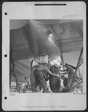 Ground Crew Members Change One Of The Huge Wheels On A Boeing B-29 "Superfortress" Based At North Field, Guam, Marianas Islands. 7 May 1945. (U.S. Air Force Number A67917AC)