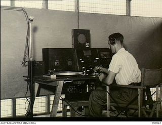 Lae, New Guinea. 1945-04-29. The control centre of the public address system at the 2/7th Australian General Hospital