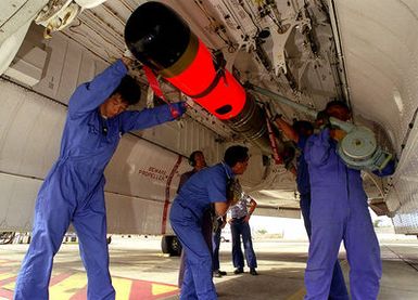 Japan Maritime Self Defense Force (JMSDF) aircrew load a Mark 46 air launched torpedo into a P-3C Orion aircraft. The torpedo will be used to test the anti-submarine warfare capabilities of the United States and Japanese navies during the exercise RIMPAC 98