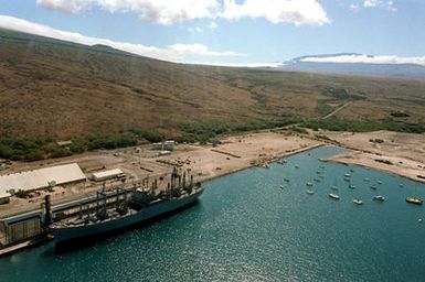 An aerial view of Kawaihae Harbor, where hundreds of vehicles of the 2nd Brigade, 25th Infantry Division, and other units wait to be loaded aboard the vehicle cargo ship USNS METEOR (T-AKR 9). The equipment is being shipped back to Oahu and Schofield Barraks after a month-long training deployment at the US Army`s Pohakuloa Training Area. (Substandard image)