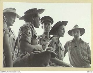 LAE, NEW GUINEA, 1945-05-07. SERGEANT J. WIEDERSEHN (1) AND PRIVATE E.M. MASON (2), COMING THROUGH THE HATCHWAY ON TO THE GANGWAY DURING DISEMBARKATION FROM THE MV DUNTROON. THE DUNTROON CARRIED A ..