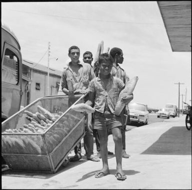 Boys with a basket full of bread sticks, Noumea, New Caledonia, 1967 / Michael Terry