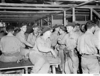 MILNE BAY, PAPUA. C. 1943-12-21. BEAUFORT BOMBER CREWS OF NO. 6 SQUADRON RAAF IN THE OPERATIONS ROOM AT A RAAF AIRSTRIP HAVING JUST RETURNED FROM A NIGHT RAID ON GASMATA