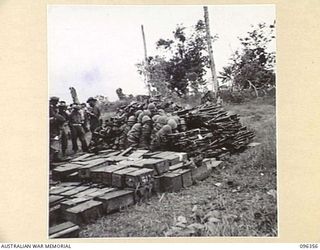 KAIRIRU ISLAND, NEW GUINEA, 1945-09-08. STAFF OFFICERS OF HQ 6 DIVISION EXAMINING A JAPANESE WEAPON DUMP. THE STAFF OFFICERS VISITED THE ISLAND TO MAKE ARRANGEMENTS WITH JAPANESE STAFF OFFICERS FOR ..