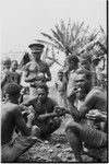 Tinami, Inland Bunabun: betel nut chewing, local police in center holds lime gourd