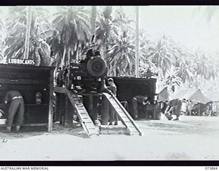 MADANG, NEW GUINEA. 1944-06-15. VX142259 DRIVER F. D. BROWN AND VX135591 CORPORAL J. D. GRIFFIN WORKING ON A JEEP AT THE MOTOR TRANSPORT SECTION, HEADQUARTERS, 15TH INFANTRY BRIGADE. THE UNIT WAS ..