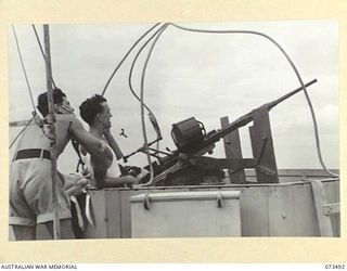 AT SEA. 1944-05-12. ONE OF THE SIX OERLIKON GUNS ABOARD THE TROOPSHIP ORMISTON FIRING DURING ANTI-AIRCRAFT PRACTICE ON THE VOYAGE FROM PORT MORESBY TO LAE