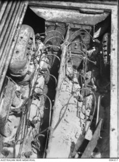 Cape Boram, Wewak area, New Guinea.  View from above of the engine in an armoured recovery variant of the medium type 97 Chi Ha tank, which was captured on the beach.  Army workshops, the tank ..