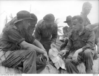SUAIN PLANTATION, NEW GUINEA. 1944-12-06. LIEUTENANT A. GOW, AUSTRALIAN NEW GUINEA ADMINISTRATIVE UNIT, (3), INDICATES INFORMATION CONCERNING TERRAIN PROVIDED BY NATIVES. LIEUTENANT-COLONEL N.W.P. ..