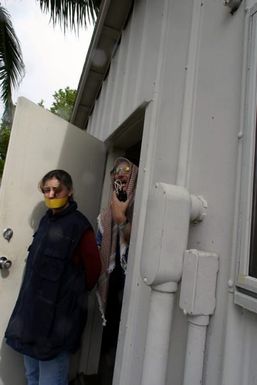 A terrorist, played by U.S. Navy Randal H. Hughes, an Assistant Special Agent in Charge of the Naval Criminal Investigative Service Hawaii Field Office, uses a hostage, played by U.S. Marine Corps CPL. Lozor, Marine Forces Pacific Band, as a human shield, during training at the Marine Corps Base Hawaii, on Dec. 9, 2004.(U.S. Marine Corps official photo by CPL. Nicholas Riddle) (Released)