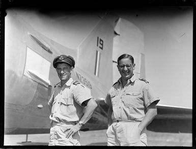 Portrait of Second Lieutenant C W Franks on right, and Flight Lieutenant N S Irvine in front of a Dakota transport plane, Tontouta Airfield, New Caledonia