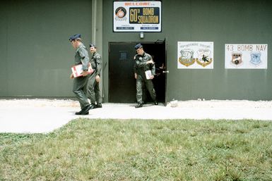 Aircrew members leave a building after a preflight briefing during exercise Glad Customer '82