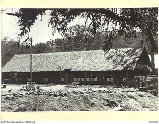 EGGY'S CORNER, PORT MORESBY, PAPUA, 1944-02-20. MOST MESS HUTS AND RECREATION HUTS AT THE 2/1ST GENERAL HOSPITAL ARE NATIVE BUILT. THE SISTER'S MESS, SHOWN HERE, IS TYPICAL OF HUTS AT THE HOSPITAL