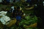 Tolai farm wives offering their produce for sale at Rabaul market, bags of lime for betal nut use, Rabaul