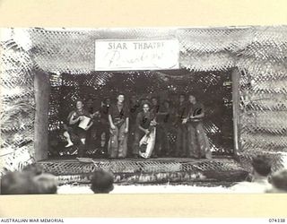 SIAR, NEW GUINEA. 144-06-25. A HILLBILLY ACT BEING STAGED BY MEMBERS OF NO. 3 PLATOON, HEADQUARTERS COMPANY OF THE 57/60TH INFANTRY BATTALION CONCERT PARTY ON THE STAGE OF THE UNIT THEATRE. ..