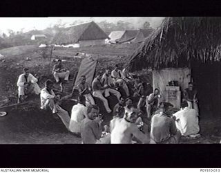 NEW GUINEA. 1942. PATIENTS EAT THEIR BREAKFAST OUTSIDE WARD 21 OF THE 2/9TH AUSTRALIAN GENERAL HOSPITAL (9AGH). (DONOR B. SHAW)