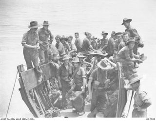 KANOMI BEACH, NEW GUINEA. 1944-01-05. TROOPS OF THE 2/23RD AUSTRALIAN INFANTRY BATTALION, 26TH AUSTRALIAN INFANTRY BRIGADE, 9TH AUSTRALIAN DIVISION ABOARD A BARGE READY FOR THEIR MOVE UP THE COAST. ..