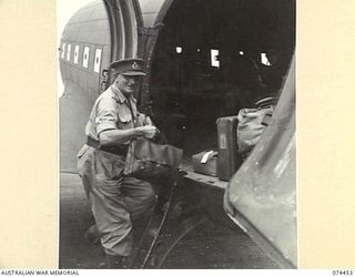 LAE, NEW GUINEA. 1944-07-06. LIEUTENANT GENERAL RICHARDSON, BRITISH ARMY LEADER OF A DELEGATION OF BRITISH ARMY OFFICERS, VISITING THE NEW GUINEA BATTLE AREAS, CLIMBING ABOARD A ROYAL AUSTRALIAN ..