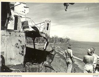 LAE AREA, NEW GUINEA. 1944-11-26. AUSTRALIAN AND ALLIED SERVICE PERSONNEL ENJOYING A SWIM IN THE WARM WATERS OF THE HUON GULF VIEWED FROM THE DECK OF THE WRECKED JAPANESE MERCHANT VESSEL MYOKO MARU ..