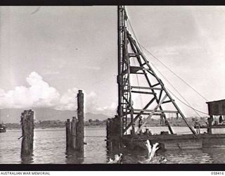 LAE, NEW GUINEA. 1943-10-13. UNITED STATES SMALL SHIPS SECTION PILE DRIVER, DRIVING PILES FOR A NEW DOCK