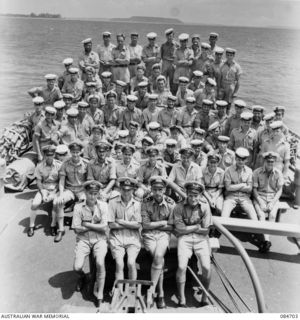 Group portrait of the ship's company aboard HMAS Glenelg. Identified, front row, left to right: Sub Lieutenant (Sub Lt) A. Brierly (1); the Captain, Lieutenant Commander Robson, Royal Australian ..