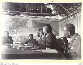 CAPE WOM, NEW GUINEA, 1945-09-13. SCENE DURING CONFERENCE BETWEEN STAFF OFFICERS OF 6 DIVISION, HEADED BY LIEUTENANT-COLONEL J. BISHOP GENERAL STAFF OFFICER I, AND STAFF OFFICERS OF 18 JAPANESE ..